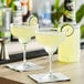 Two margaritas made with Finest Call Premium Margarita Mix on a bar table.
