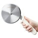 A hand holding a Dexter Russell pizza cutter with a white handle.