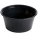 A black plastic Dart souffle cup with a black rim.