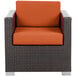 A BFM Seating Aruba wicker armchair with rust canvas cushions on a white background.