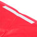 A red plastic tablecloth with white elastic.