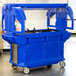 A navy blue Cambro Versa Ultra food/salad bar with clear top on wheels.