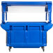 A blue Cambro food cart with clear lids on a counter.