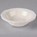A white Tuxton scalloped edge bowl.