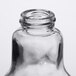 An American Metalcraft glass lightbulb salt and pepper shaker set. A close-up of a clear glass lightbulb.