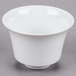 A CAC Citysquare white porcelain cup on a gray surface.