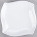 A white irregular square melamine platter with a curved edge.