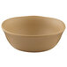 A close-up of a beige Elite Global Solutions round melamine bowl.