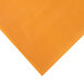 A Creative Converting pumpkin spice orange plastic tablecover on an orange surface.