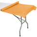 A roll of Creative Converting Pumpkin Spice Orange plastic table cover on a table with a white top.