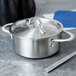 A stainless steel Clipper Mill mini serving pot with a lid on a counter.