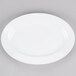 A white Elite Global Solutions oval melamine plate on a gray surface.