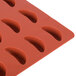 A red silicone Martellato tangerine slice mold with 24 compartments.