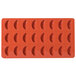 A red Martellato silicone mold with 24 tangerine slice shapes.