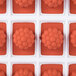 A red silicone Martellato fruit jelly mold with 24 raspberry-shaped compartments.