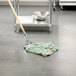 A Rubbermaid wet mop head on a floor.