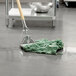 A Rubbermaid green blend wet mop head on the floor.