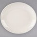 An ivory Homer Laughlin oval platter on a gray surface.
