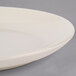 A close up of a Homer Laughlin ivory oval platter with a rim.