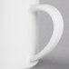 A close-up of a white Libbey stacking porcelain mug with a handle.