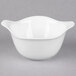 A white bowl with a porcelain handle.
