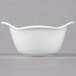A close-up of a Libbey white porcelain bowl with a handle.