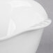 A close up of a Libbey Royal Rideau white porcelain bowl with a handle.