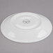 A white Libbey Royal Rideau porcelain tea saucer with a small circular design.