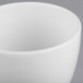 A close-up of a Libbey Royal Rideau white porcelain bouillon cup.