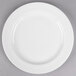 A Libbey round white porcelain plate with a white rim on a gray surface.