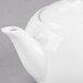A white Libbey Royal Rideau porcelain teapot with a lid.
