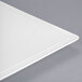A white square porcelain plate with a square edge and a corner.