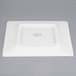 A white square Libbey porcelain plate with a logo.