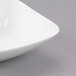 A close-up of a Libbey Royal Rideau white square porcelain bowl.