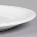A close up of a Libbey white porcelain plate with a narrow rim.
