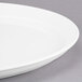 A close-up of a white Libbey porcelain tray with a rim.