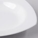 A white square porcelain deep bowl on a white surface.