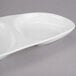 A white porcelain oval serving tray with 3 wells.