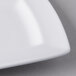 A close-up of a white Libbey rectangular porcelain plate with a wide rim.