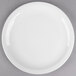 A Libbey round white porcelain plate with a narrow white rim on a gray surface.