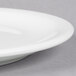 A close up of a Libbey white porcelain plate with a narrow rim.