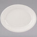 A white Tuxton oval china platter with a ribbed edge.