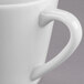 A close-up of a white Libbey Royal Rideau tea cup with a handle.