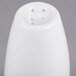 A white porcelain Libbey pepper shaker with holes in it.