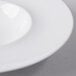 A close-up of a Libbey Royal Rideau white porcelain super bowl with a white rim.