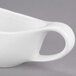 A white Libbey Royal Rideau porcelain sauce boat with a handle.