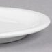 A close-up of a Libbey white porcelain plate with a narrow rim.