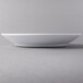 A white Libbey Royal Rideau porcelain entree and pasta bowl on a white plate.