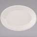 A white oval Tuxton China platter with a ribbed edge and decorative pattern.