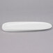 A white porcelain oval tray with a curved edge.